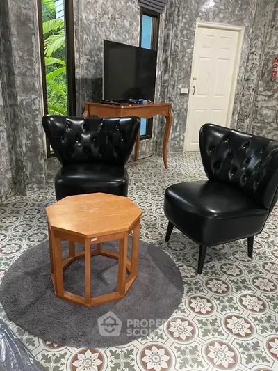 Stylish living room with elegant black chairs and unique patterned flooring