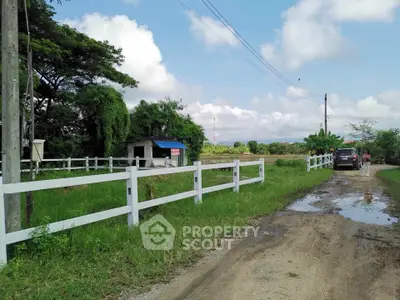 Charming rural property with lush greenery and white fence, perfect for countryside living.