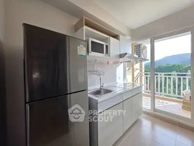 Modern kitchen with sleek appliances and balcony view