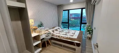 Cozy bedroom with modern decor and large window offering a scenic view