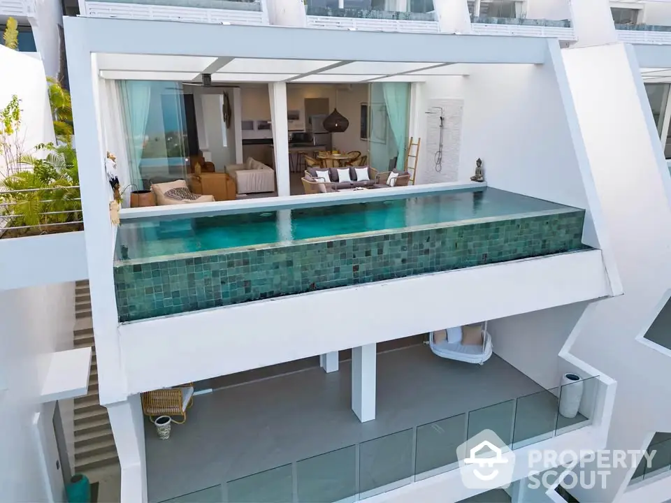 Luxurious modern villa with infinity pool and spacious balcony overlooking scenic views