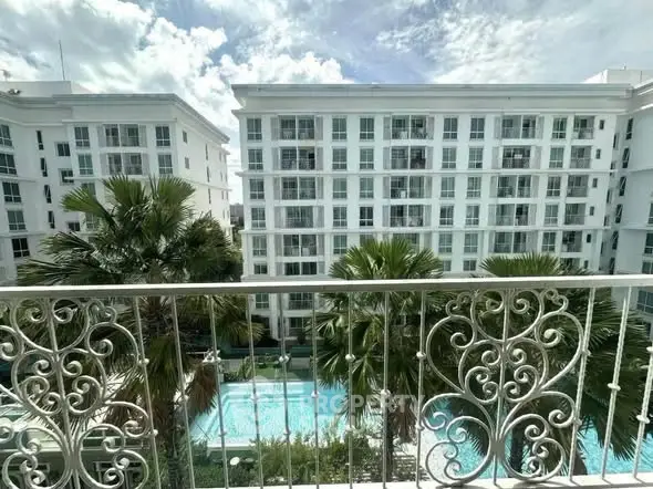 Luxurious apartment view with pool and palm trees, perfect for resort-style living.