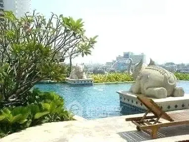 Luxurious rooftop pool with stunning city views and elegant sculptures, perfect for relaxation and leisure.