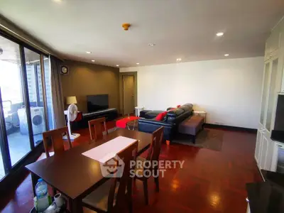Spacious living room with modern furniture and large windows offering natural light.