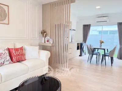 Modern open-plan living and dining area with stylish decor and natural light.