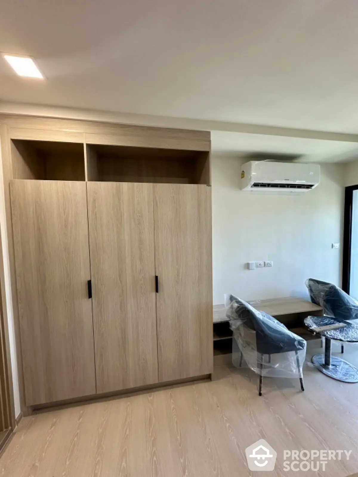 Modern living room with sleek furniture and air conditioning in a stylish apartment.