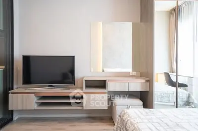 Modern bedroom with sleek TV unit and cozy decor