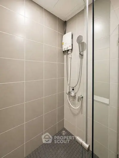 Modern bathroom with sleek shower and neutral tiles, perfect for a minimalist home design.
