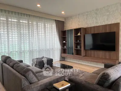 Luxurious living room with modern decor, large windows, and elegant furniture, perfect for relaxation and entertainment.