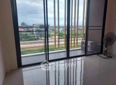 Spacious room with large windows offering a stunning view and access to a private balcony.