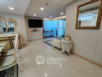 Luxurious living room with elegant decor and stunning city view from large windows.