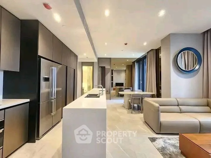 Luxurious open-plan living room with modern kitchen and elegant decor