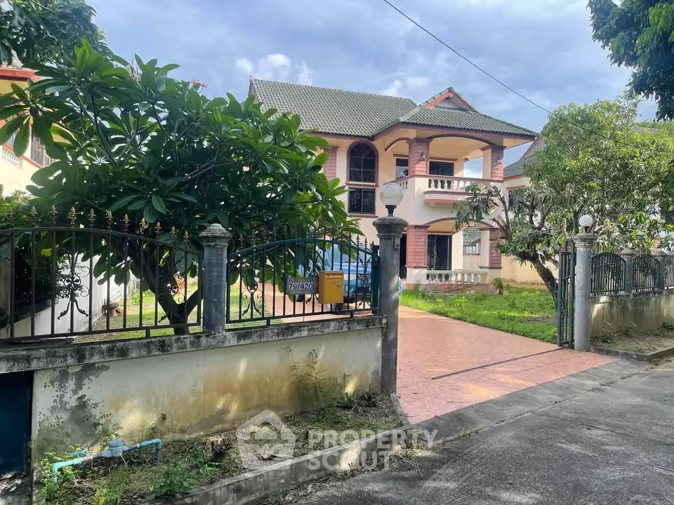 Charming two-story house with lush garden and spacious driveway in a serene neighborhood.