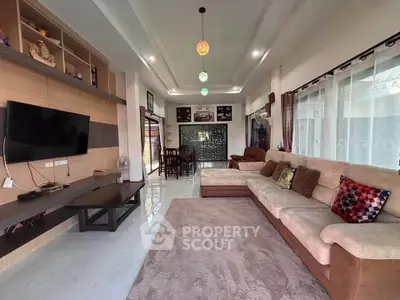 Spacious living room with modern decor and large sectional sofa, perfect for family gatherings.