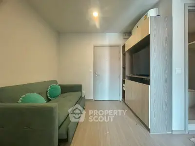 Cozy living room with modern sofa and built-in TV unit, perfect for relaxation.