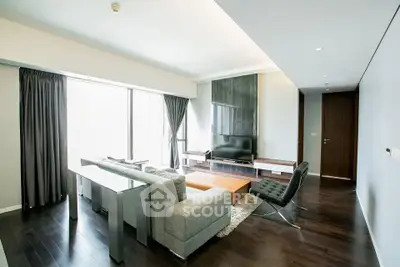 Spacious modern living room with sleek furniture and large windows