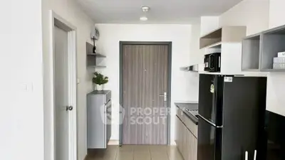 Modern kitchen with sleek black appliances and minimalist design