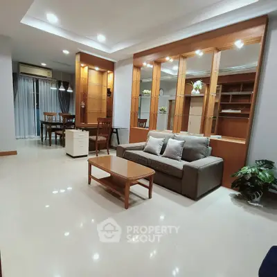 Spacious living room with elegant wooden cabinetry and modern furnishings