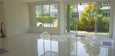 Spacious living room with large windows and garden view