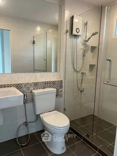 Modern bathroom with glass shower and stylish tile accents