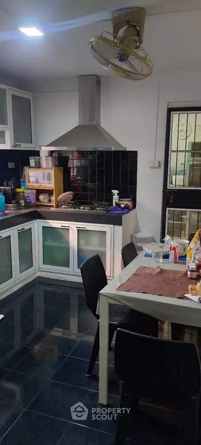 Spacious kitchen with modern appliances and dining area, perfect for family gatherings.