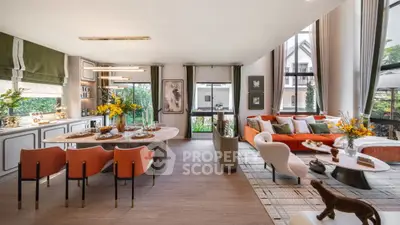 Luxurious open-plan living and dining area with modern decor and large windows.