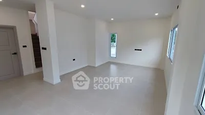 Spacious unfurnished living room with large windows and modern lighting