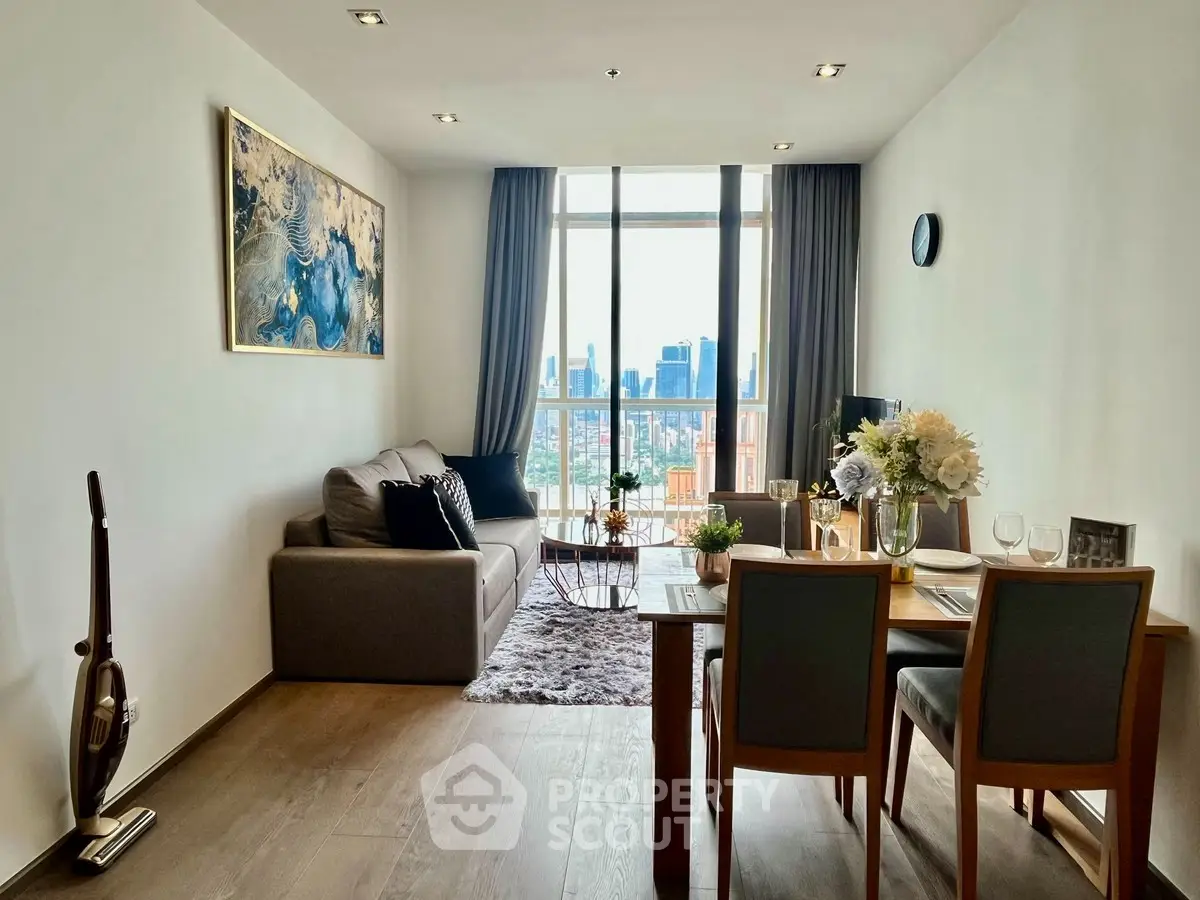 Modern living room with city view, stylish decor, and dining area in a high-rise apartment.