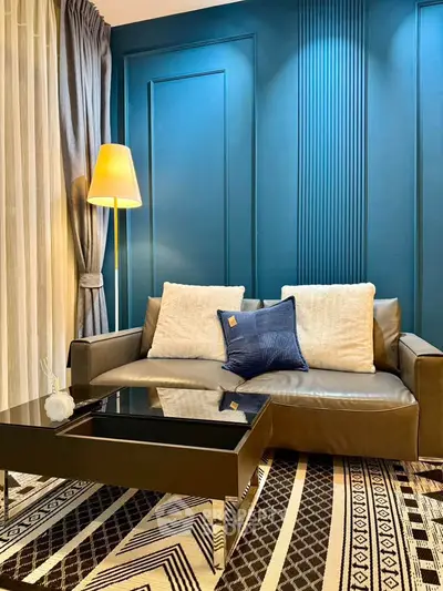 Stylish living room with modern sofa, chic decor, and elegant lighting in a contemporary setting.
