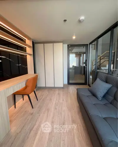 Modern living room with stylish furniture and wooden flooring in a contemporary apartment.