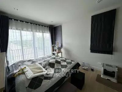 Cozy bedroom with large window and modern decor