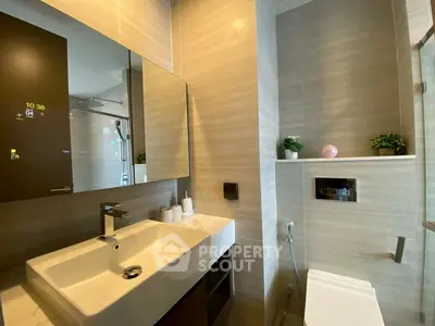 Modern bathroom with sleek sink and stylish fixtures in a contemporary apartment.