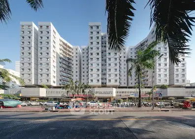 Stunning high-rise building with modern architecture and vibrant street view, perfect for urban living.