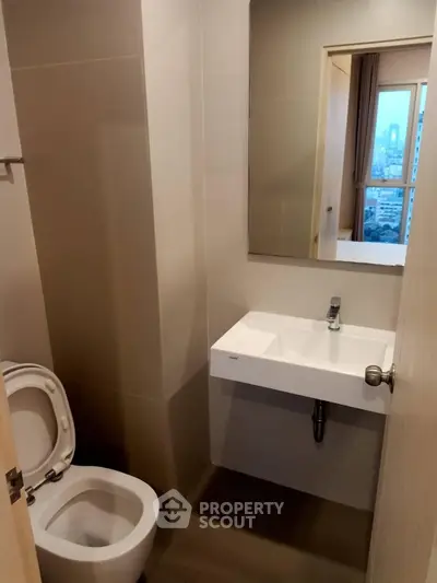Modern bathroom with sleek sink and city view from window