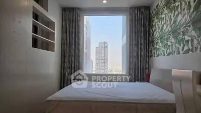 Modern bedroom with large window offering stunning city view and stylish decor.