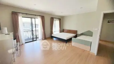 Spacious bedroom with large windows and modern furnishings