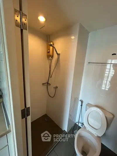 Compact bathroom with shower and toilet in modern apartment