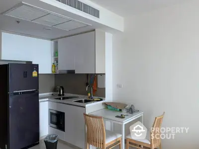 Modern compact kitchen with dining area in a stylish apartment