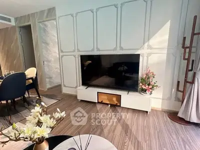 Stylish living room with modern decor and elegant TV setup.