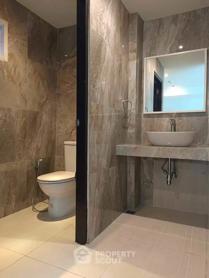 Modern bathroom with elegant stone tiles and sleek fixtures