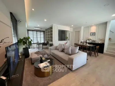 Spacious modern living room with elegant decor and open dining area, perfect for entertaining.