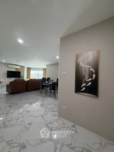 Spacious modern living room with elegant marble flooring and stylish decor
