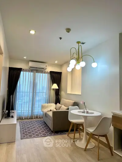 Modern living room with cozy seating and stylish lighting in a contemporary apartment.