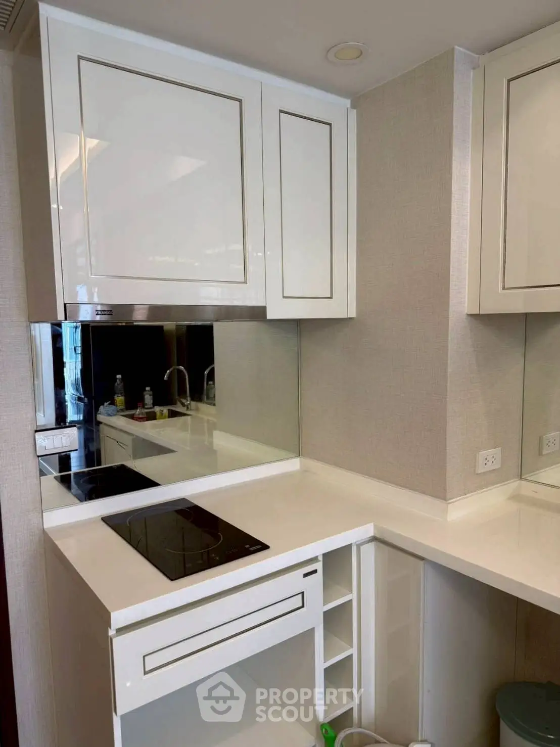 Modern kitchen with sleek white cabinetry and built-in electric stove