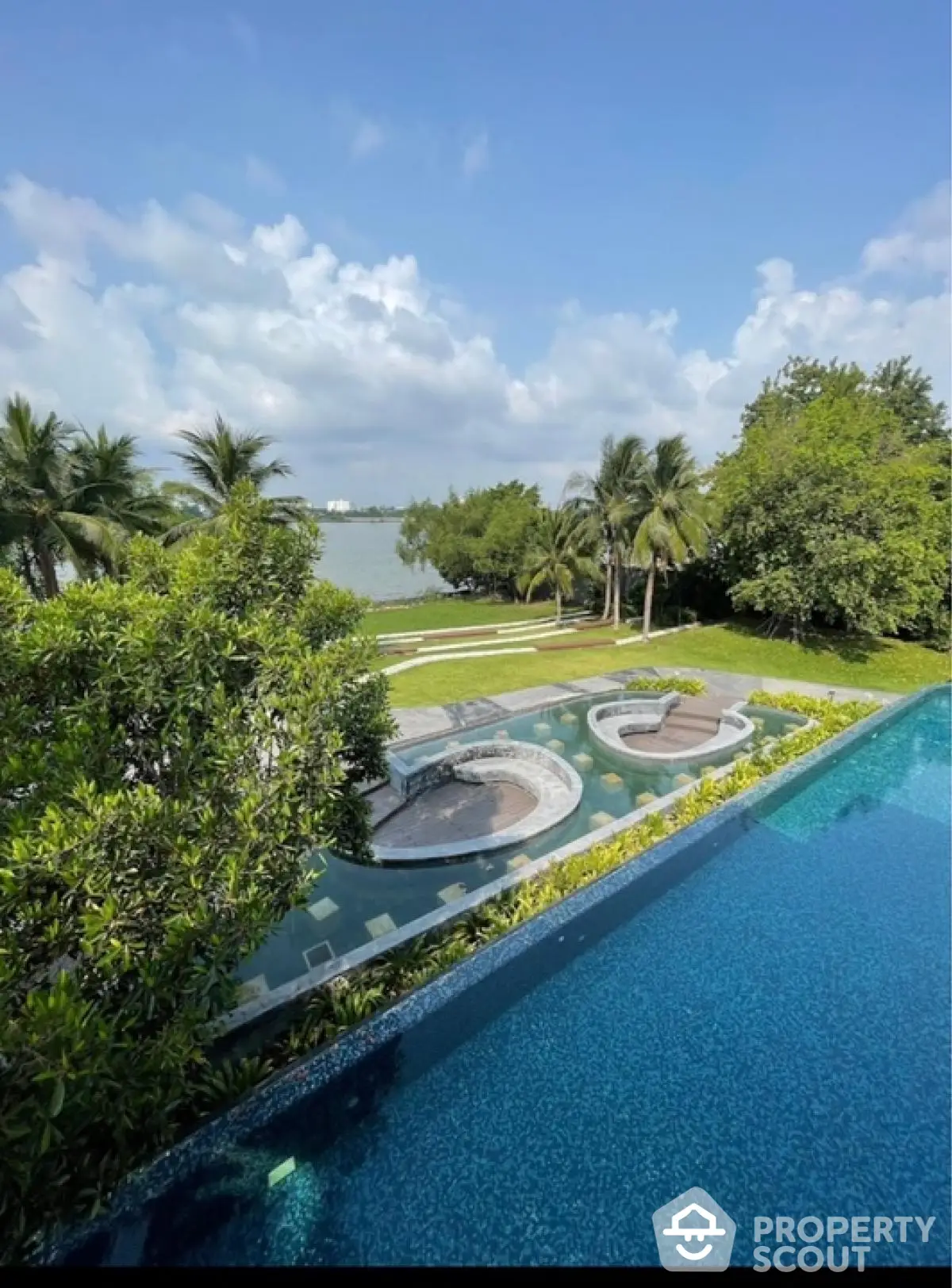 Luxurious waterfront property with stunning pool and lush greenery