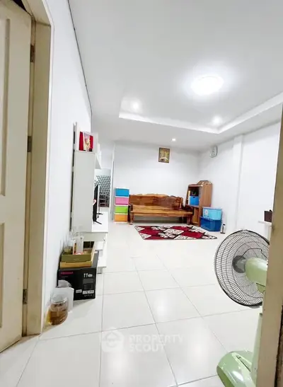 Spacious living room with modern decor and ample natural light