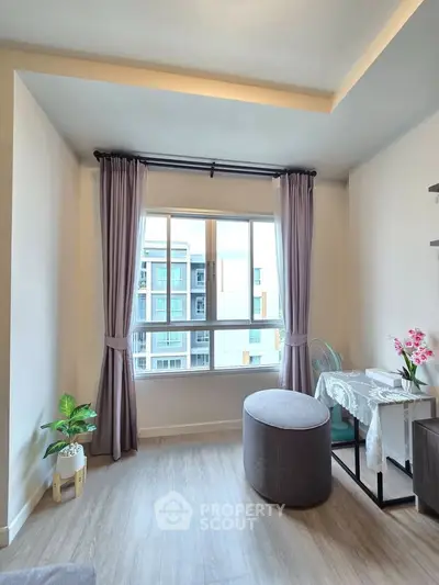 Bright living room with large window and modern decor in urban apartment