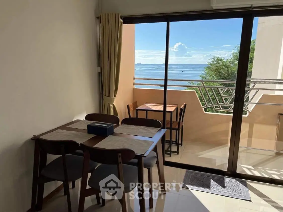 Charming dining area with ocean view from balcony, perfect for seaside living.