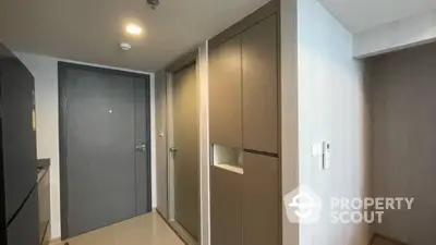 Modern apartment entrance with sleek storage cabinets and minimalist design.