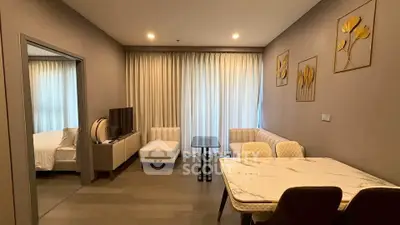 Modern living room with elegant dining area and cozy bedroom view